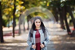 Portrait of a Stylish Pretty Young Woman in Autumn Fashion Coat outdoors.