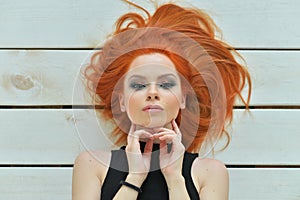 Portrait of stylish redhead young woman posing