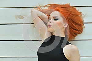 Portrait of stylish redhead young woman posing