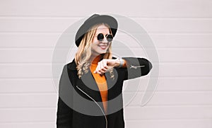 Portrait stylish smiling woman with smart watch using voice command recorder or takes calling