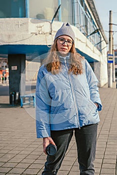 Portrait of a stylish woman in blue jacket