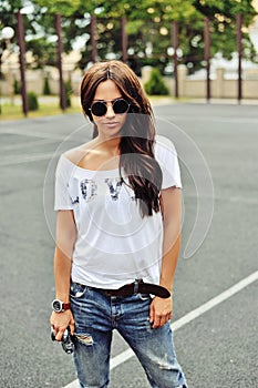 Portrait of stylish young brunette woman in casual clothes with