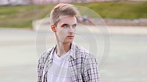 Portrait of stylish young man model looking away on city street