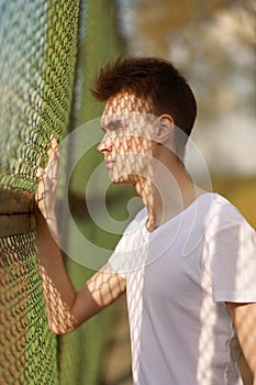 Portrait stylish young man in sunny summer day