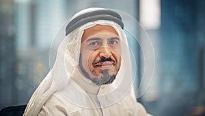 Portrait of Successful Arab Businessman in Traditional Outfit Gently Smiling, Wearing White Kandur