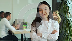 Portrait of successful beautiful executive asian businesswoman smart casual wear looking at camera and smile, arms