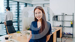 Portrait of successful beautiful executive businesswoman smart casual wear looking at camera and smiling, happy in modern office