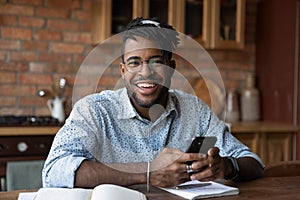 Portrait of successful black male modern day student holding smartphone