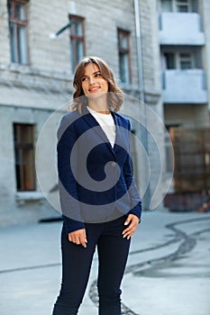 Portrait of a successful business woman in front of modern business building.