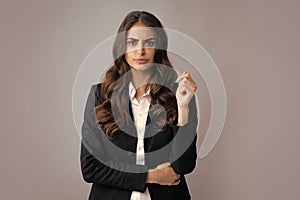 Portrait of successful business woman in suit on gray isolated background. Serious office female worker, manager