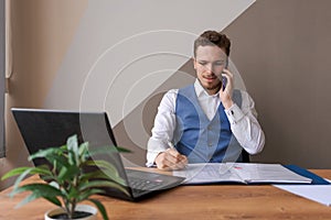 Portrait successful businessman with beard using smartphone and working