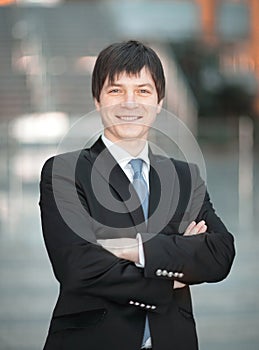 Portrait of successful businessman on blurred background office.