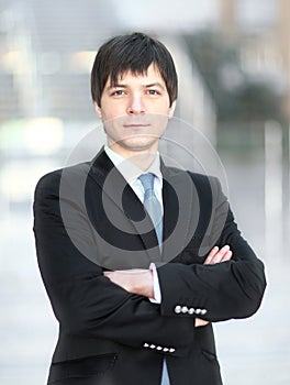 Portrait of successful businessman on blurred background office.