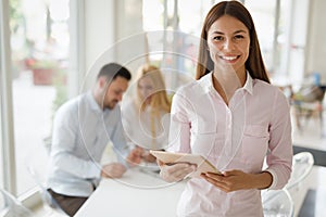 Portrait of successful businesswoman holding digital tablet