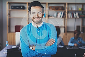 Portrait of successful confident hispanic businessman smiling at the camera in modern office.Horizontal,blurred