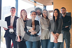 Portrait of successful creative business team looking at camera and smiling. Diverse business people standing together at startup