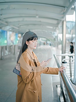 Portrait of successful, employee businesswoman. Beautiful, Asian young woman happy smile using smartphone