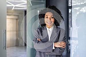 Portrait of successful female boss in business suit, mature African American woman smiling and looking at camera with