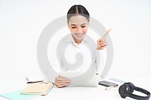 Portrait of successful female employee, asian woman talks via digital tablet on video chat, has online meeting with