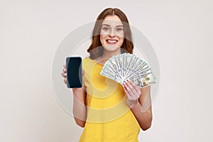 Portrait of successful happy young woman with pleasant smile wearing casual style T-shirt holding