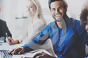 Portrait of successful hispanic businessman smiling on the business meeting with partners in modern office.Horizontal photo