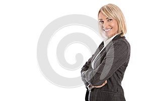 Portrait: Successful isolated older or mature blond businesswoman in blazer and white blouse.