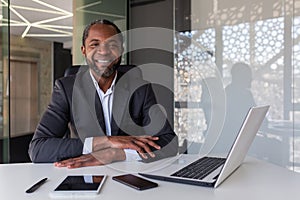 Portrait of successful mature adult businessman, man with crossed arms smiling and looking at camera, african american
