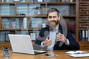 Portrait of successful mature businessman inside office at workplace, senior experienced man smiling and looking at