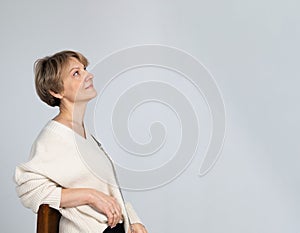 Portrait of successful mature woman. Confident woman on light gray background. Profile View, banner