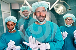 Portrait of a successful medical surgeon team inside operating room