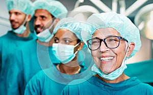 Portrait of a successful medical surgeon team inside operating room