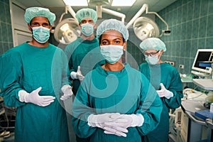 Portrait of a successful medical surgeon team inside operating room