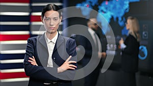 Portrait of successful mixed race brunette woman in suit white collar posing at hi tech office