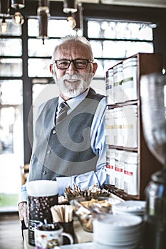 Portrait of successful senior businessman at his company.