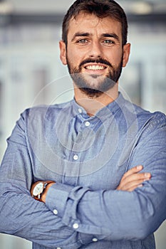 Portrait of successful smiling businessman at office