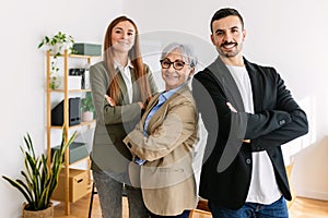 Portrait of successful three business people smiling at camera at office