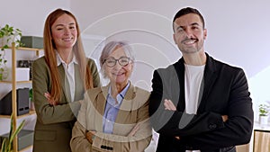 Portrait of successful three business people smiling at camera at office