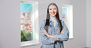 Portrait of the Successful young teenage girl Crossing Her Arms and Smiling. Beautiful Female Executive