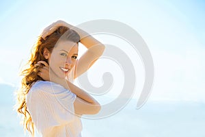 Portrait of summer young woman outdoors. Soft sunny colors.