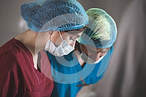 Portrait of surgeons at work, operating in uniform.