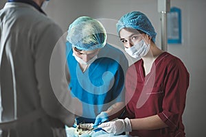 Portrait of surgeons at work, operating in uniform, looking at camera.