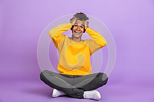 Portrait of surprised african american boy shouting and grabbing