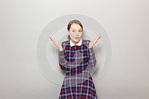 Portrait of surprised amazed girl raising hands up