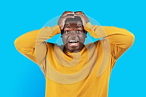 Portrait Of Surprised Black Man Touching Head And Opening Mouth In Amazement