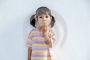 Portrait of surprised cute little toddler girl child standing isolated over white background. Looking at the camera. hands near