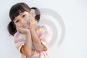 Portrait of surprised cute little toddler girl child standing isolated over white background. looking at the camera. hands near