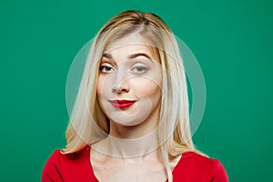 Portrait of Surprised Girl with Red Sensual Lips in Studio on Green Background.