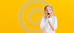Portrait of surprised little boy, emotional kid isolated on bright yellow background with. Concept of child emotions