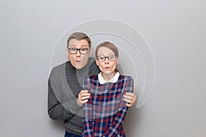 Portrait of surprised man and woman with widened eyes and open mouth