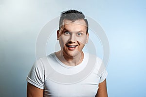 Portrait of a surprised and shocked man close-up on a light background. The concept of human emotions